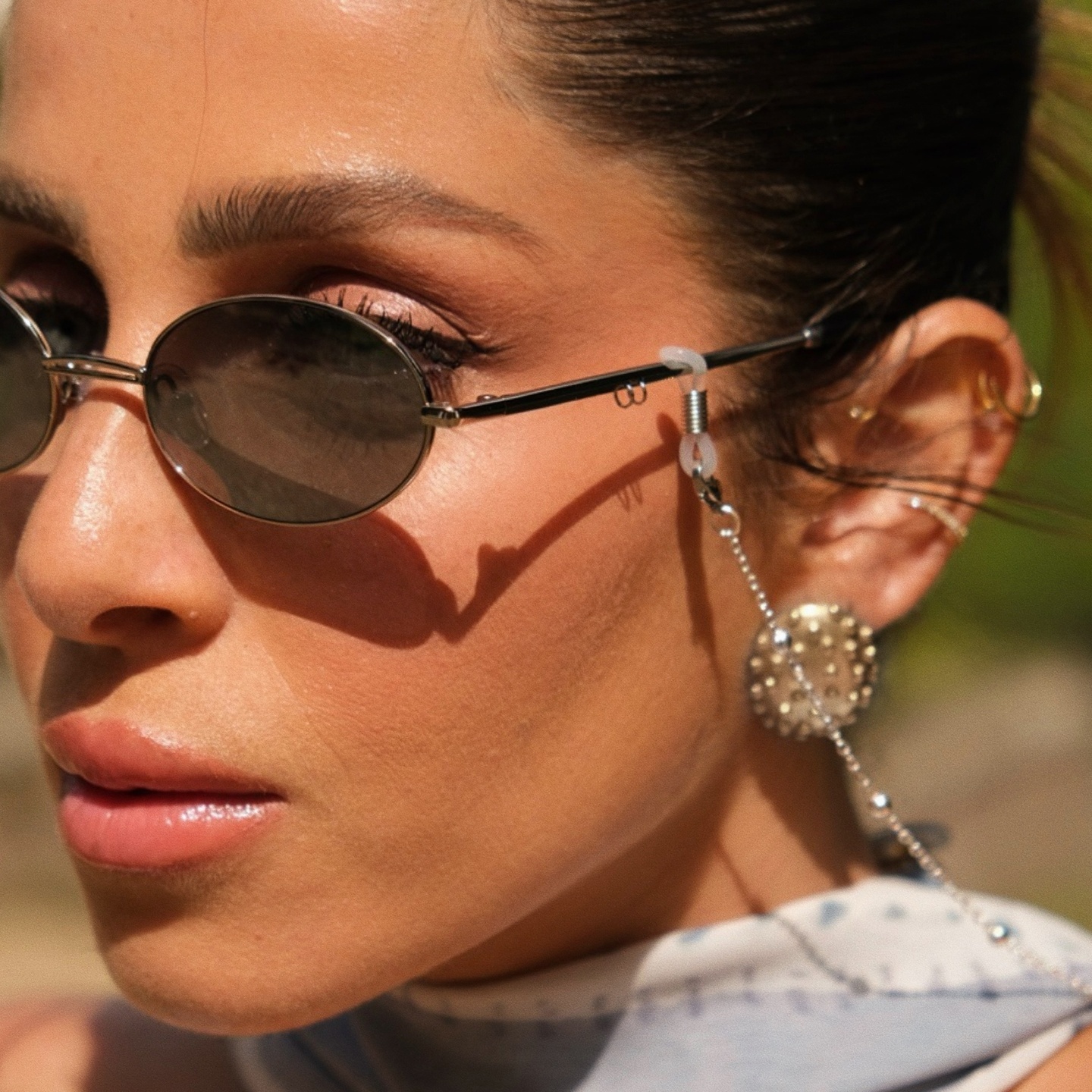 Shop TRICE Mila Chain Oval Sunglasses in Light Gold online.