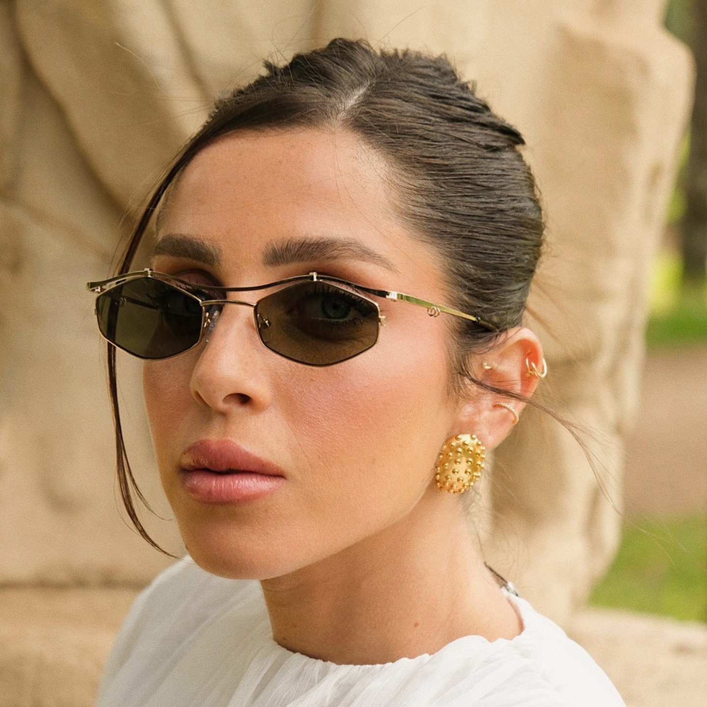 Shop TRICE Leila Edgy Irregular Sunglasses in Gold online.